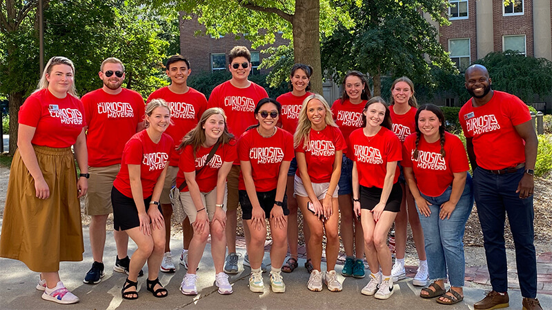 Students wearing same t-shirt pose during service day