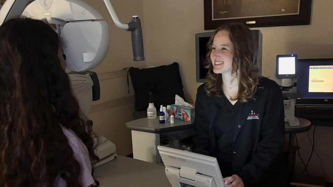 Claire Husen assisting a patient in a clinic setting.