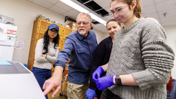 Alan Christensen (center-left) and Rebecca Varney (center-right) operate a new GelDoc Go machine with students to view the results of an experiment. The machine was purchased through a gift from Dr. Dane Todd, UNL alumnus and former Husker football player.